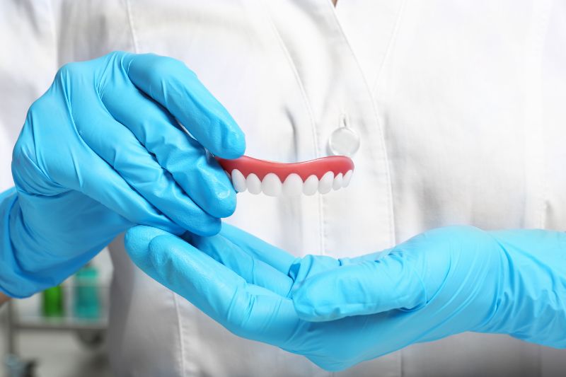 Dentist holding teeth cover, closeup view